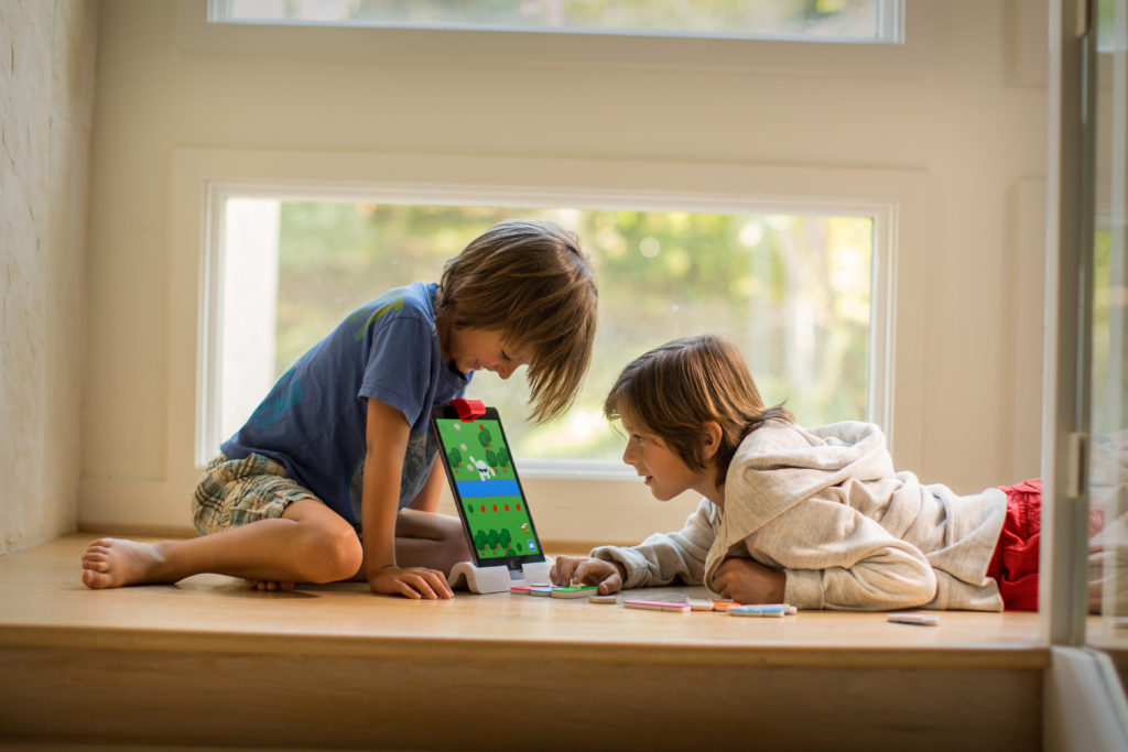 Boys play Osmo Coding